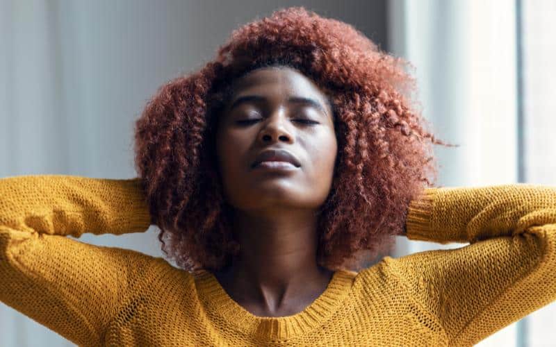 Woman stretching arms behind head